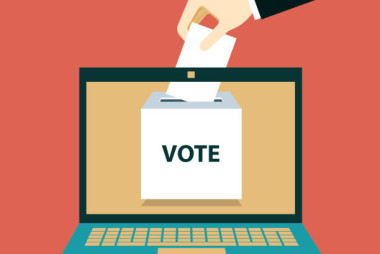 Online vote concept. Ballot box on monitor screen. Electronic referendum or election background. Hand holding paper ballot page. stock illustration